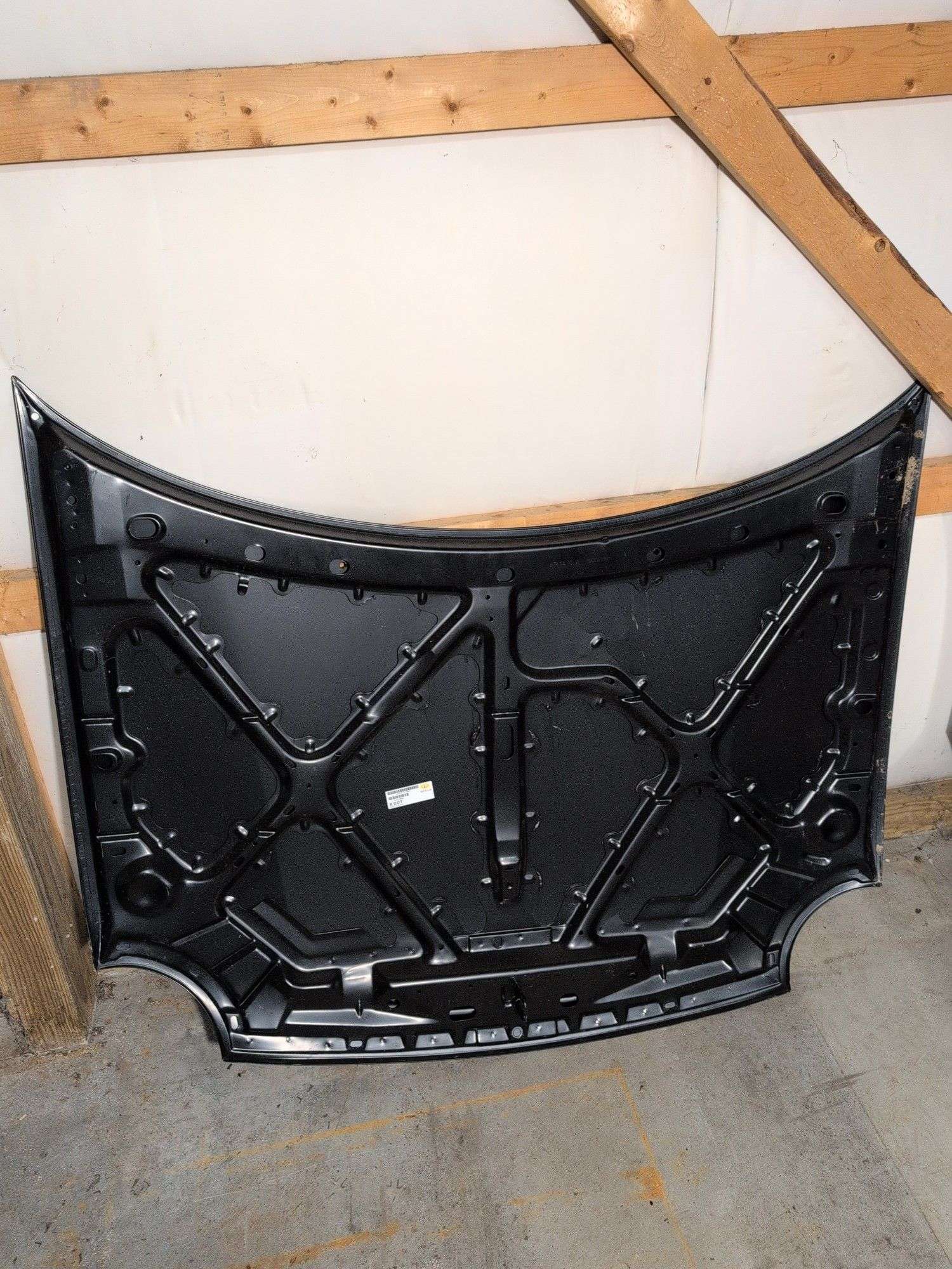 Unmarked black vehicle hood - see photos