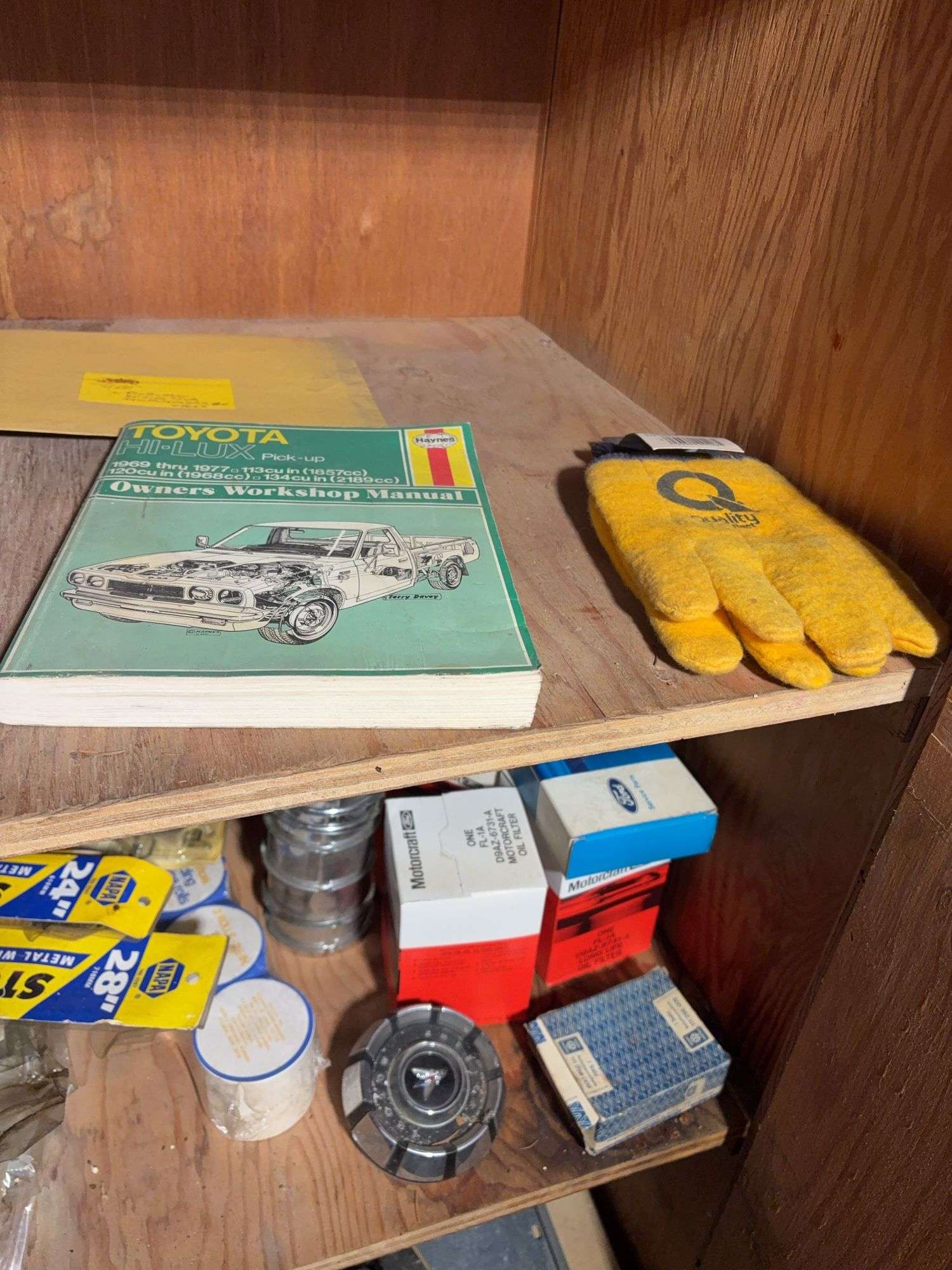 Contents of cabinet - oil filters, wiper blades, CB radios, manuals, and more