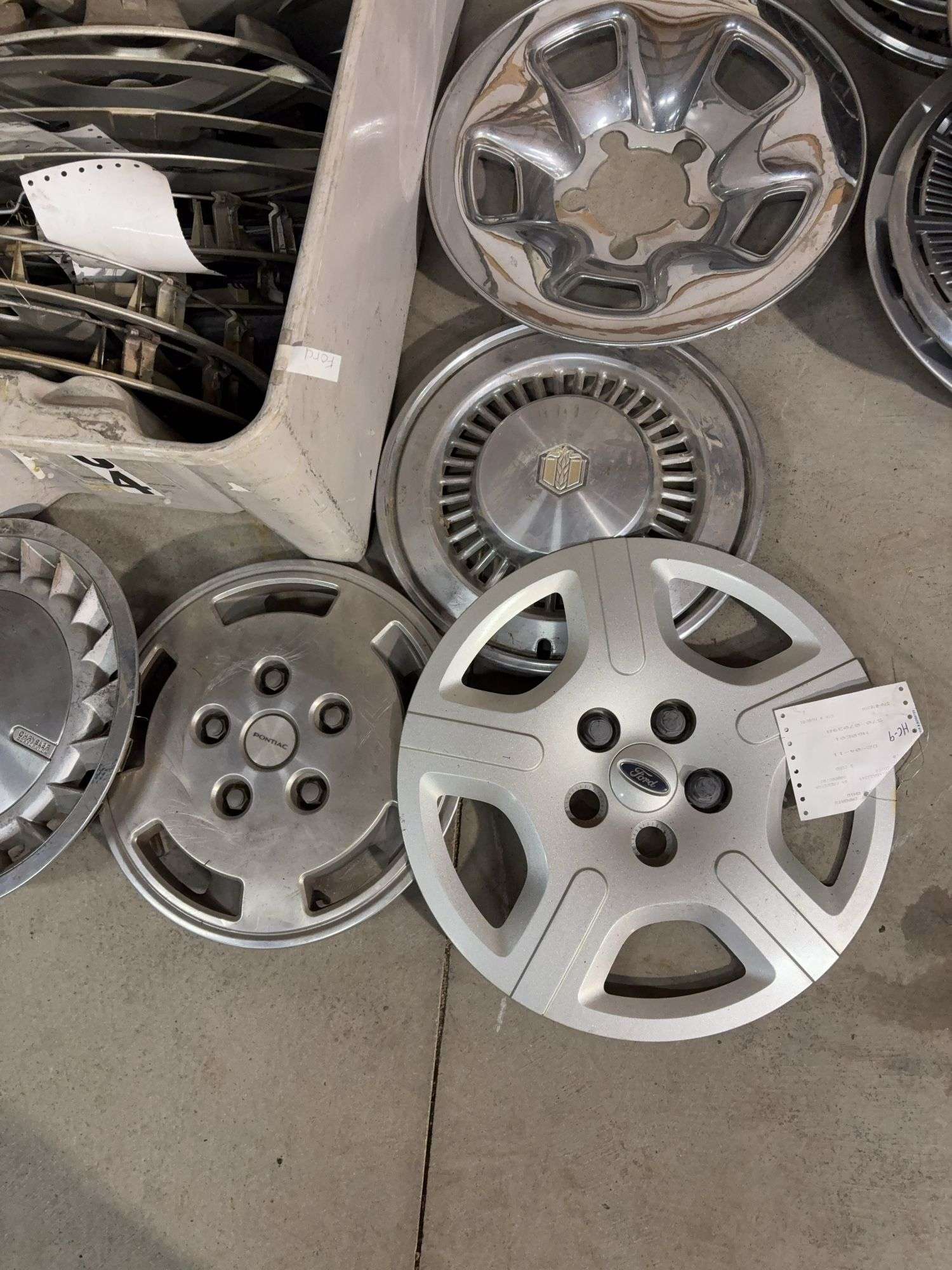 Large tote of hub caps and parts -Pontiac, Chrysler and more
