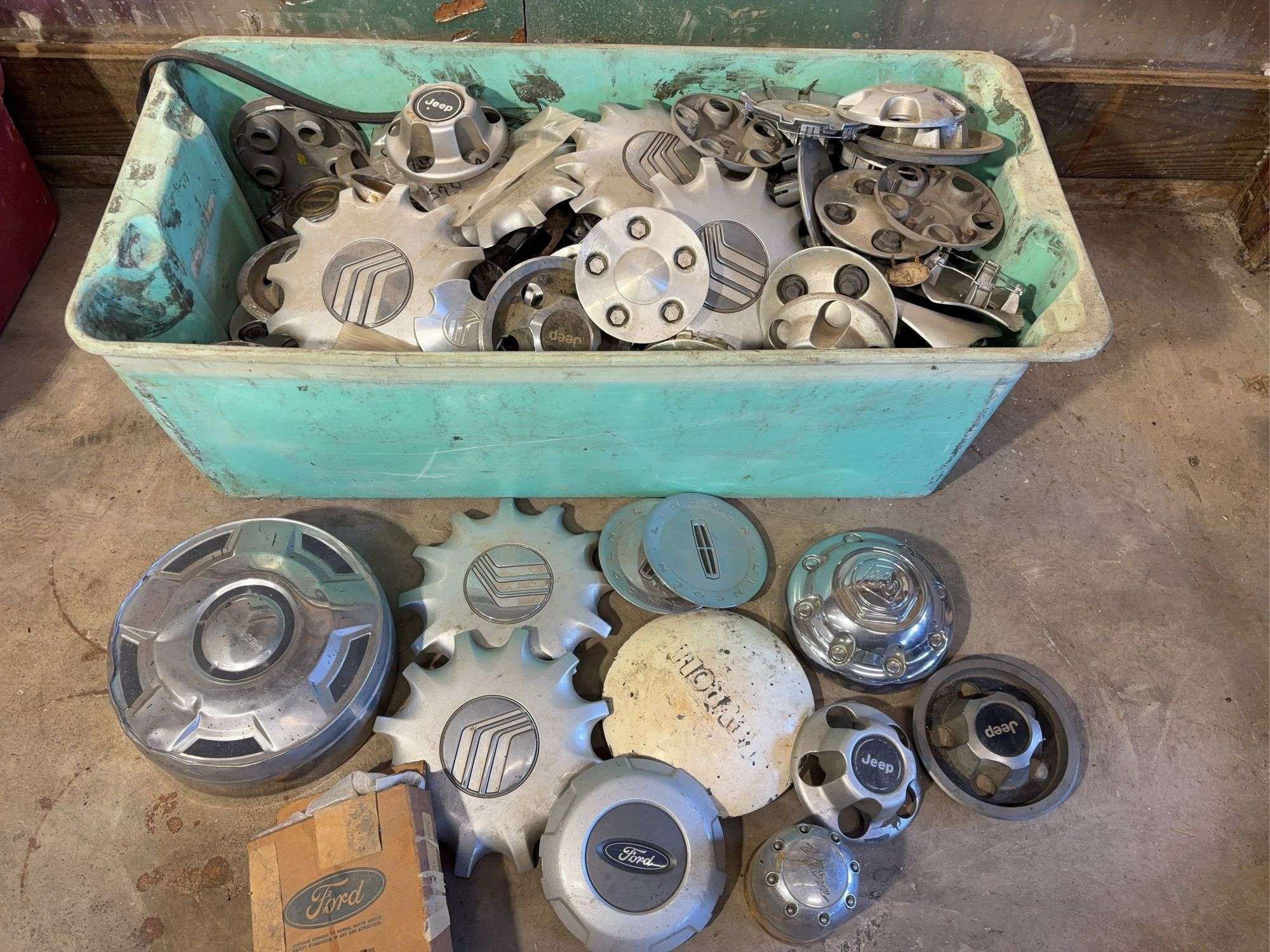 Large tote of miscellaneous hub caps and parts -Jeep, Lincoln, Ford and more