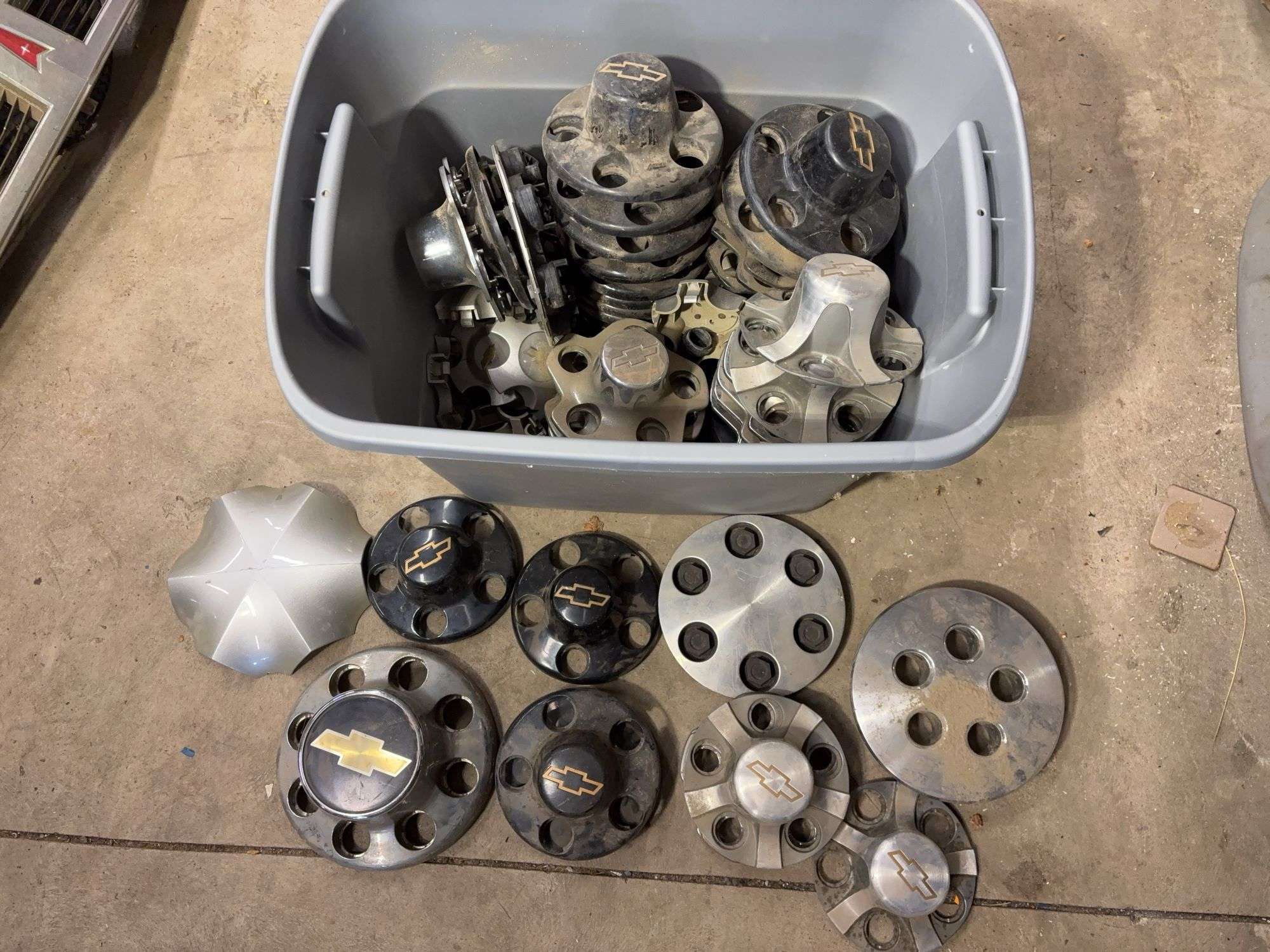 Tote of Chevy hub caps and parts