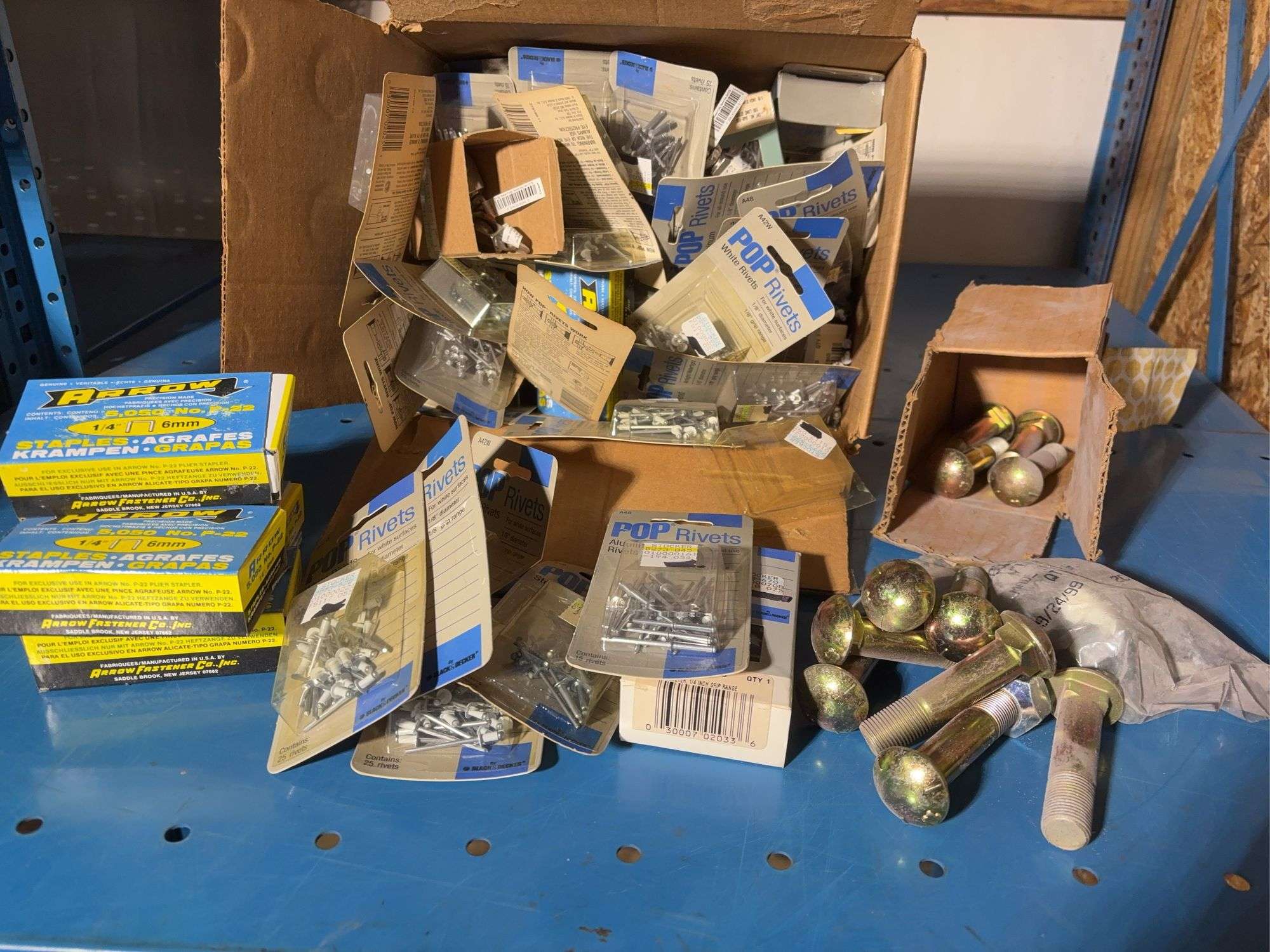 Box of pop rivets mostly unopened, Arrow staples, New Holland parts and more