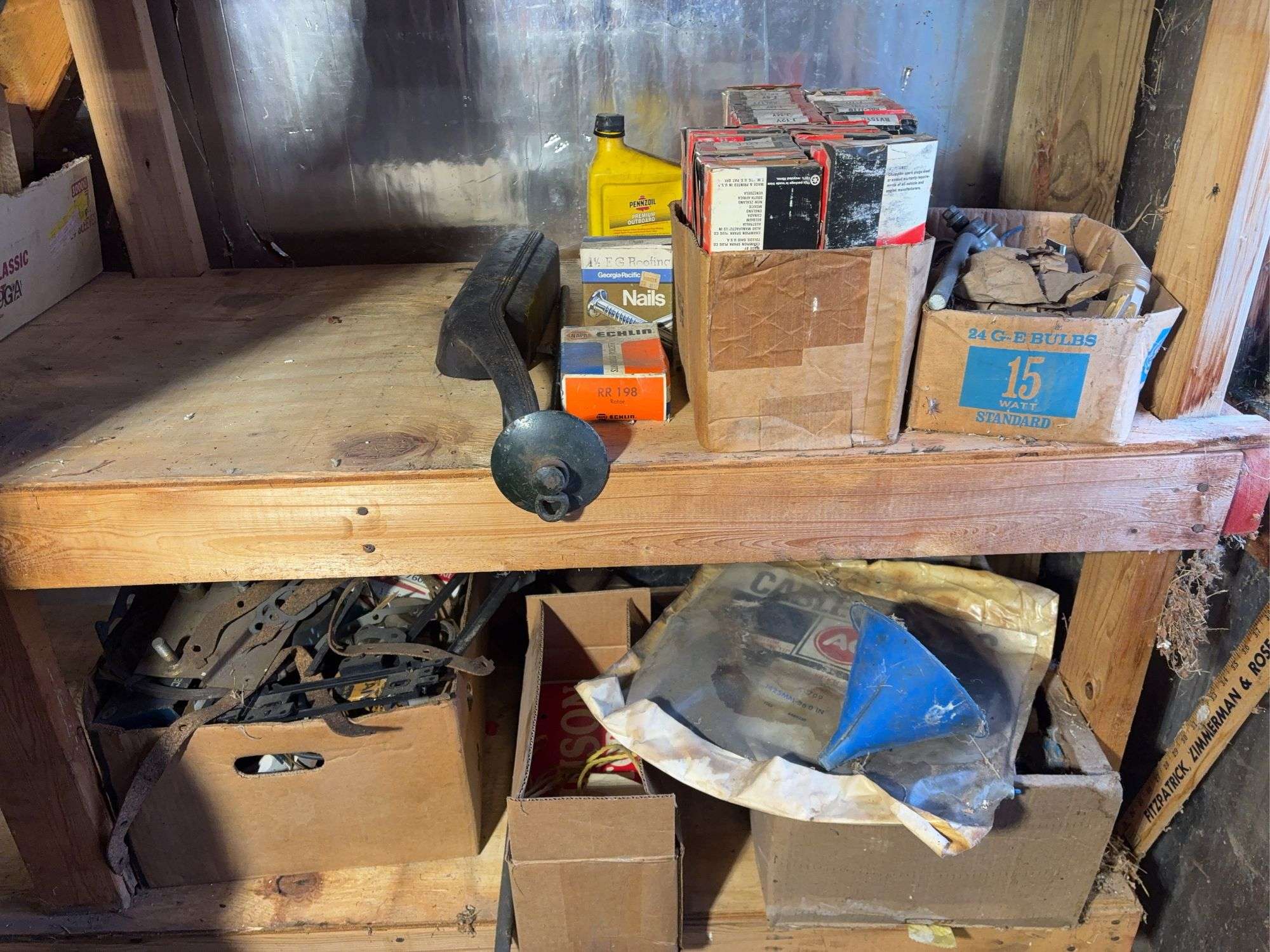 (2) shelves of vehicle-related items - sparkplugs, signs, and more