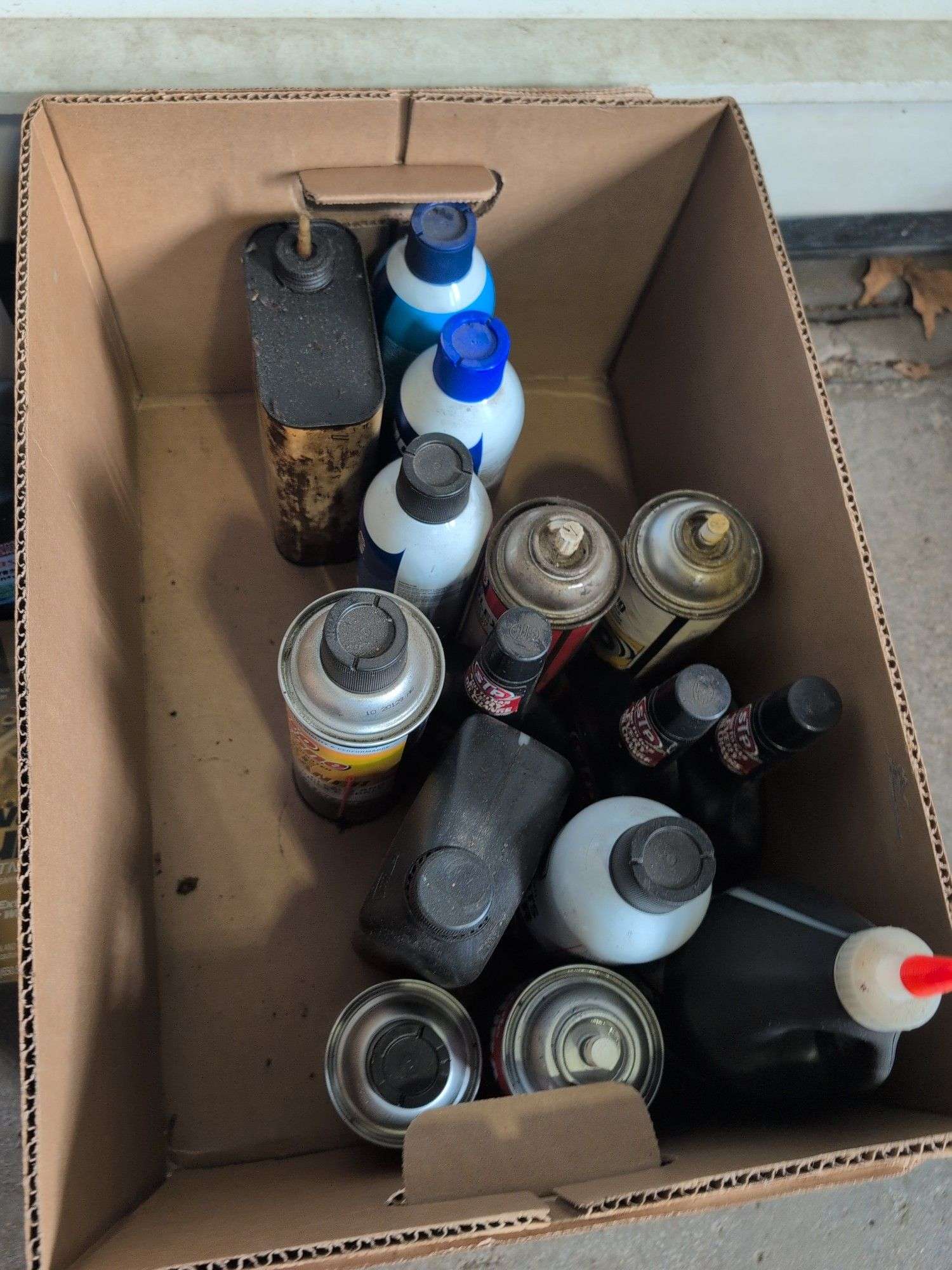 Assortment of mechanic fluids and some tools