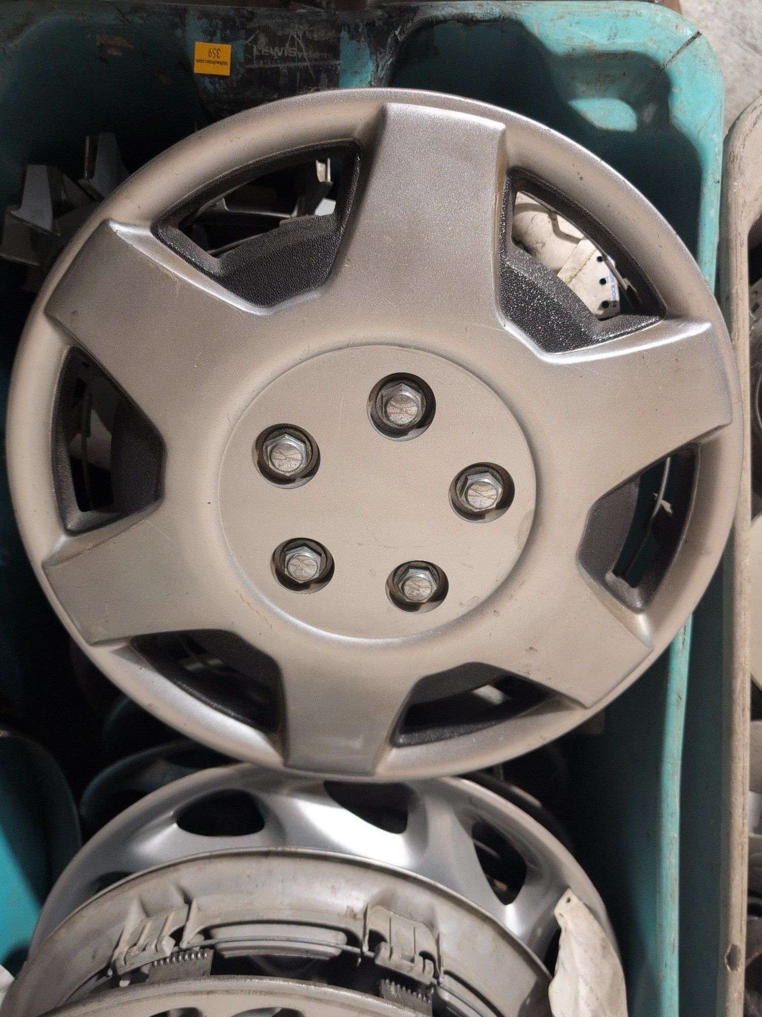 Tote of hubcaps - Mazda and others