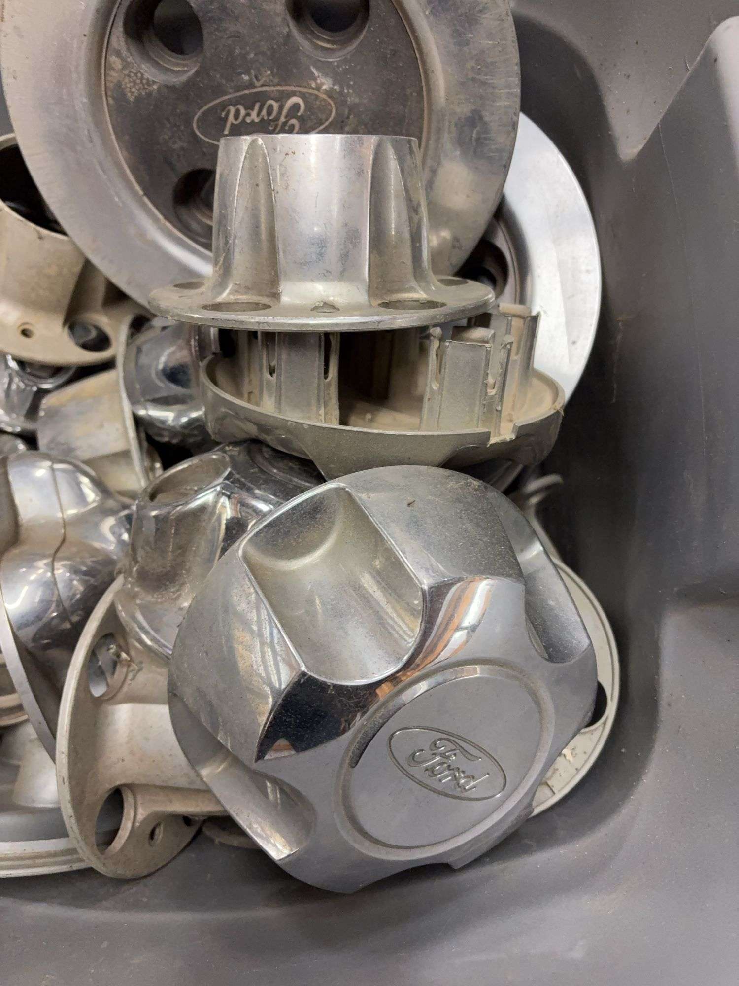 Tote of Ford hub caps and parts