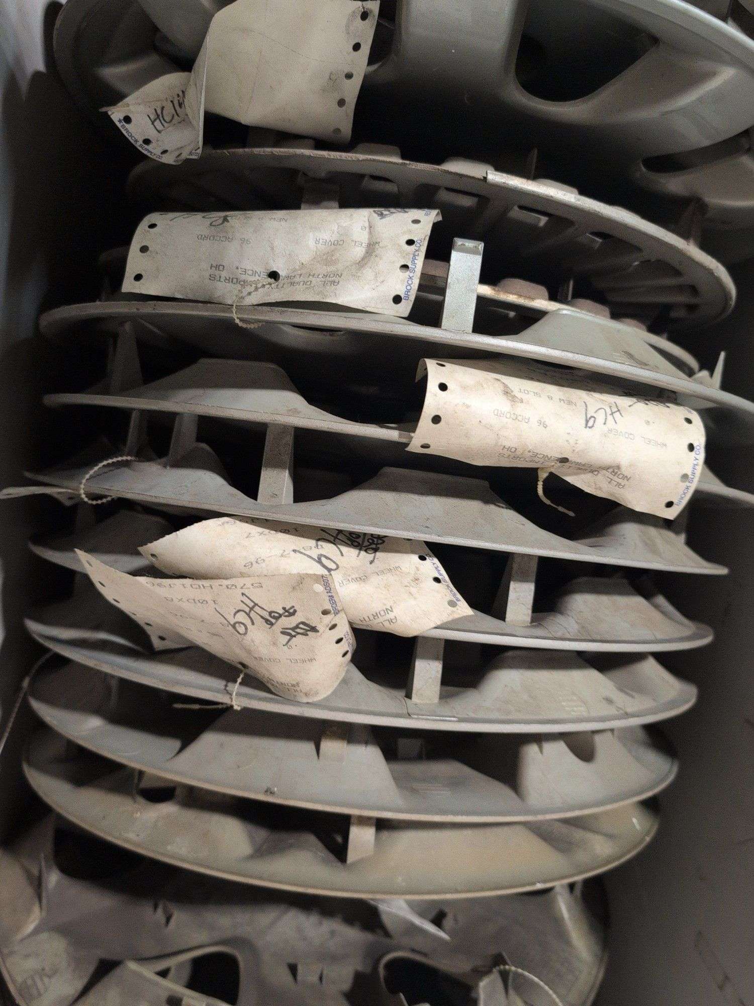 Tote of hubcaps - Honda, Cadillac, and more