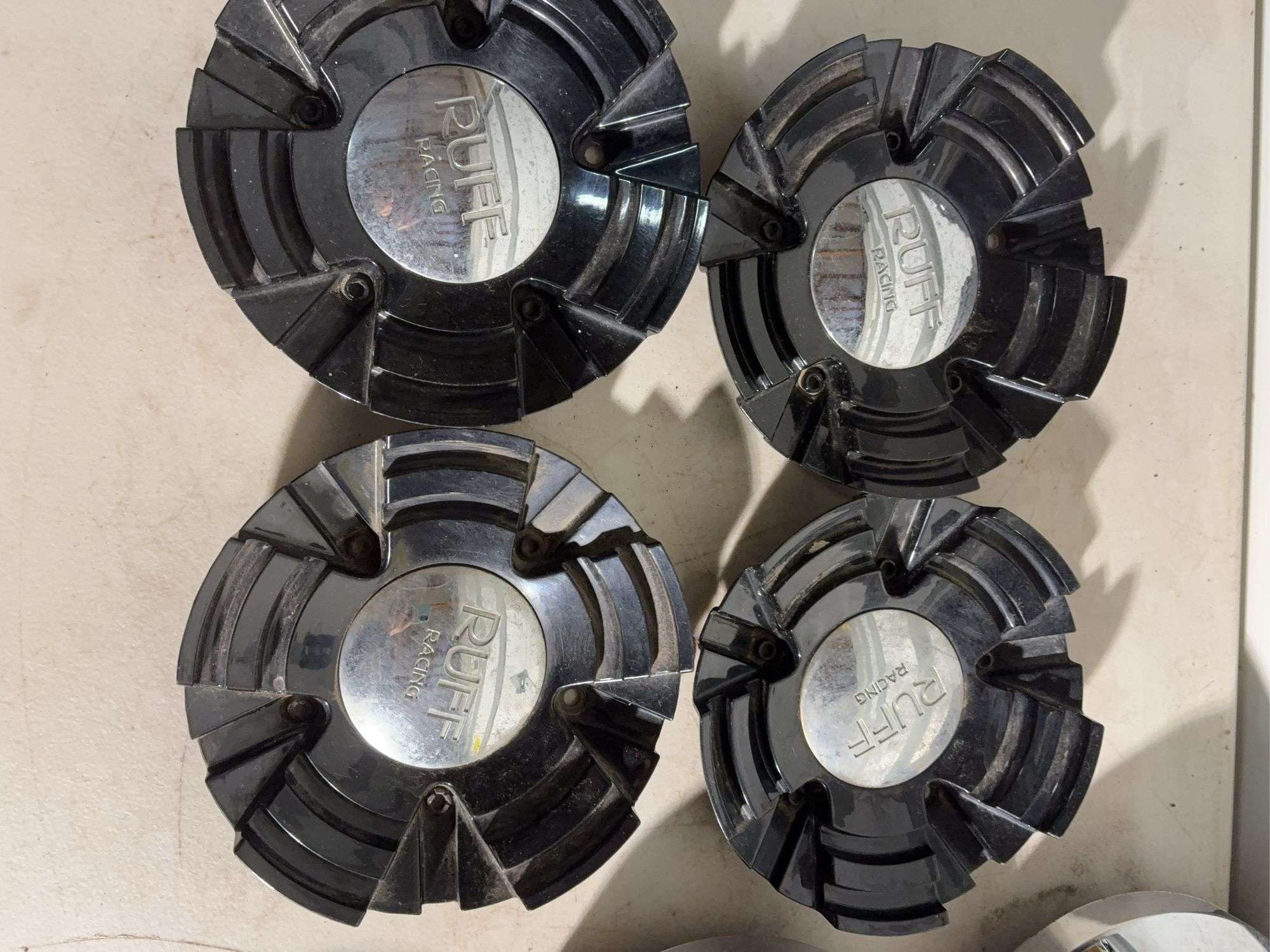 Box of Ford and Ruff racing hub caps