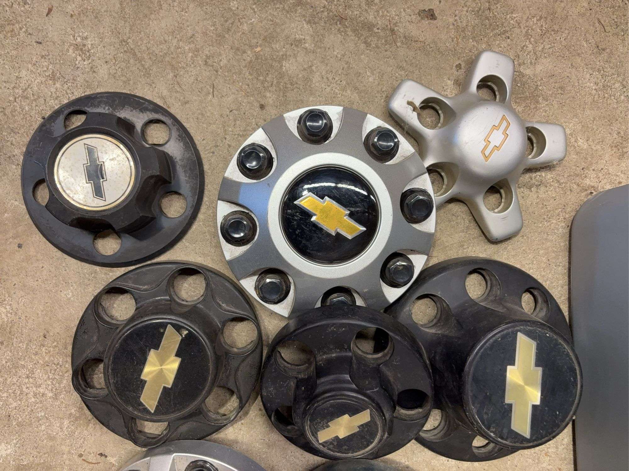 Tote of Chevy hub caps and parts