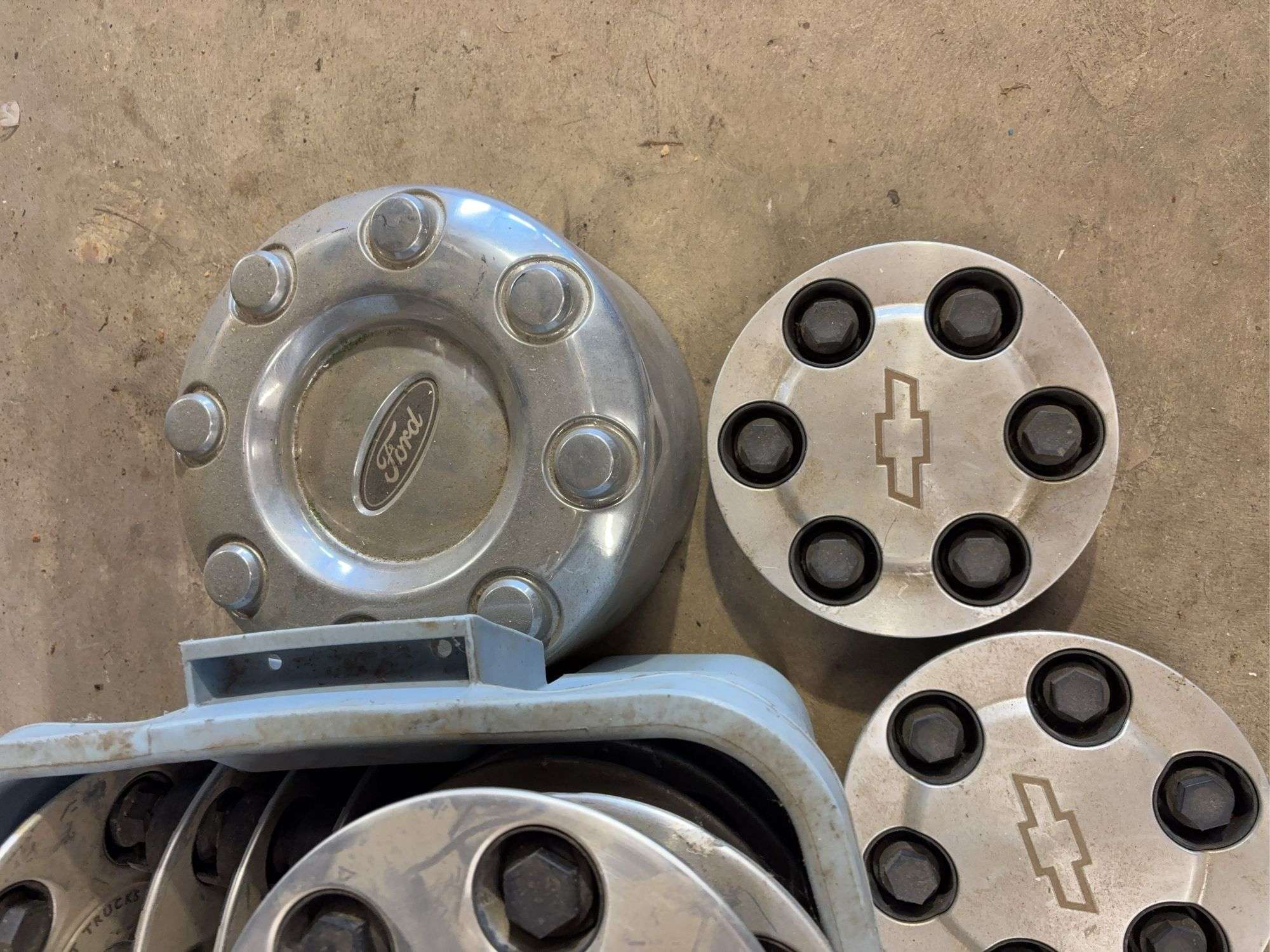 Tote of mostly Chevy hub caps and parts -see photos