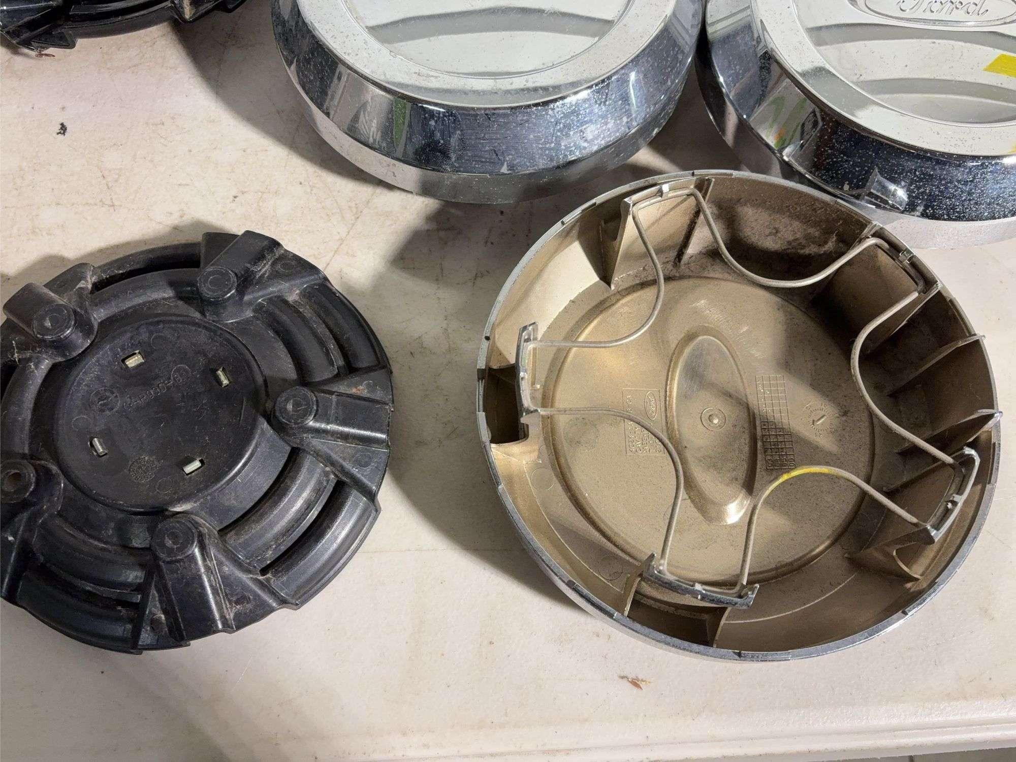 Box of Ford and Ruff racing hub caps