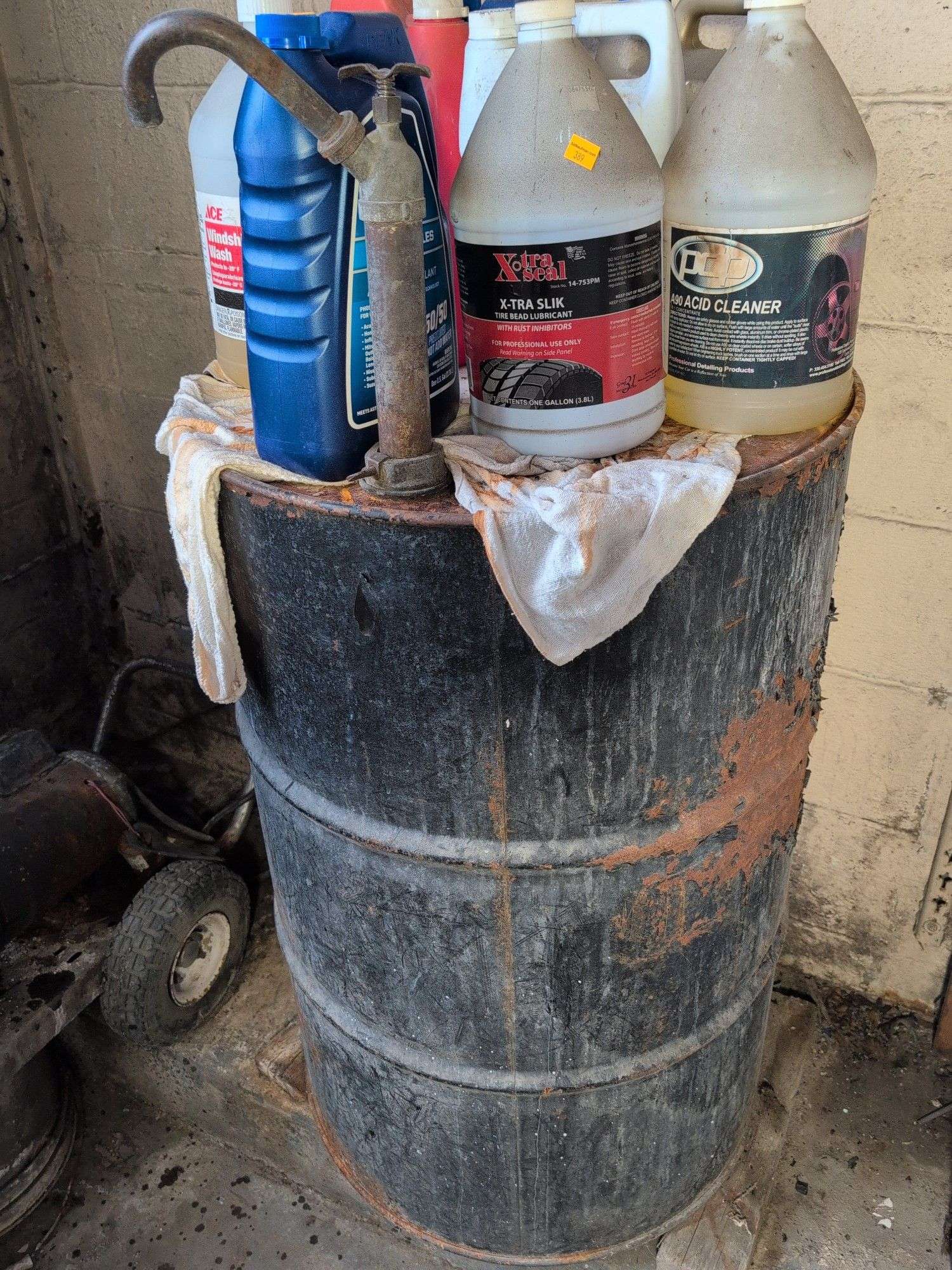 55 gallon metal drum with some antifreeze