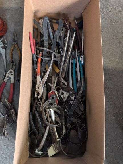 Box of tools - wrenches, pliers, grease gun, and more