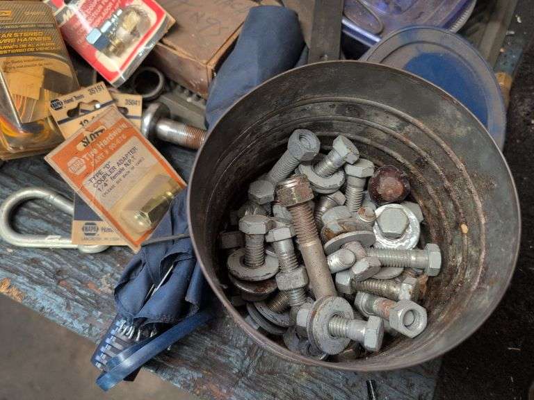 Assortment of items - tape, nuts and bolts, gloves, and more