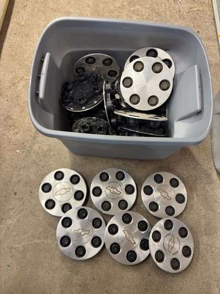 Tote of Chevy hub caps and parts