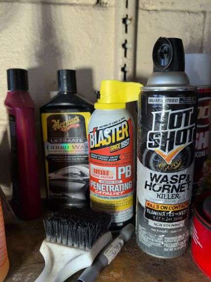 Shelf of cleaners, sprays, and other vehicle fluids
