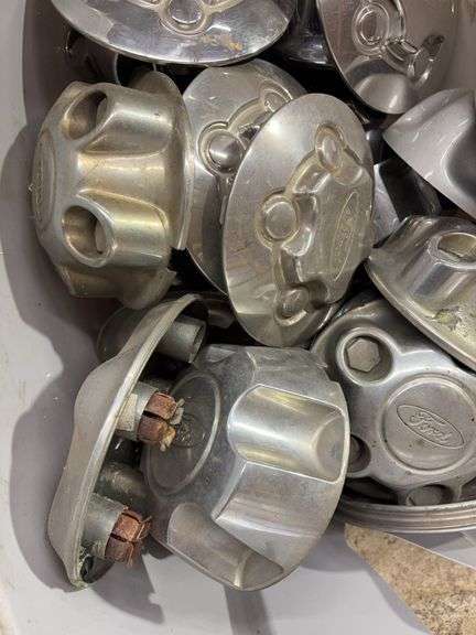 Tote of Ford hub caps and parts