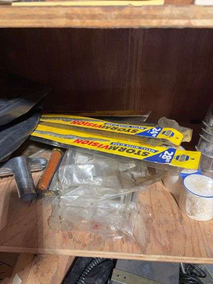 Contents of cabinet - oil filters, wiper blades, CB radios, manuals, and more