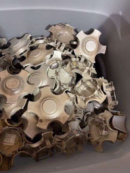 Tote of Chevy and Ford hub caps and parts