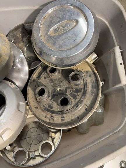 Tote of hub caps and parts -Nissan, Chevy, Ford and more