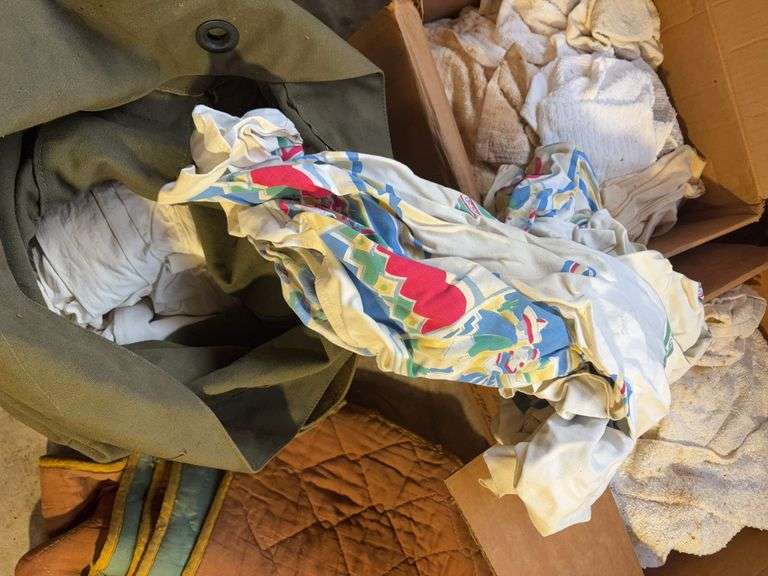 Boxes of rags, military bag, and blankets