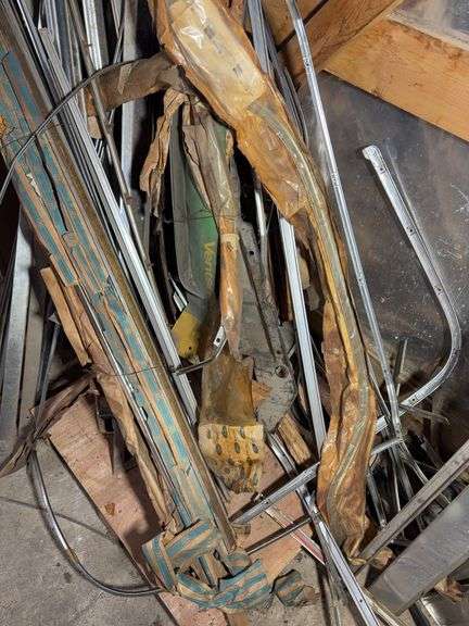 Corner of car parts and scrap metal pieces - as is