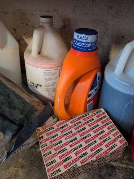 Shelf of shop rags and vehicle fluids