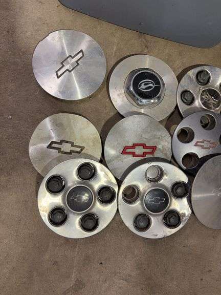 Tote of Chevy hub caps and parts