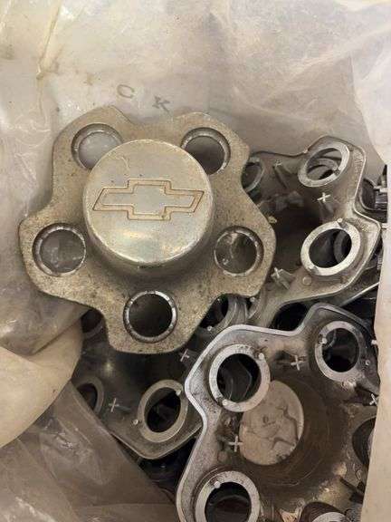 Tote of hub caps and parts -Chevy, Buick, and more