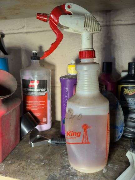 Shelf of cleaners, sprays, and other vehicle fluids