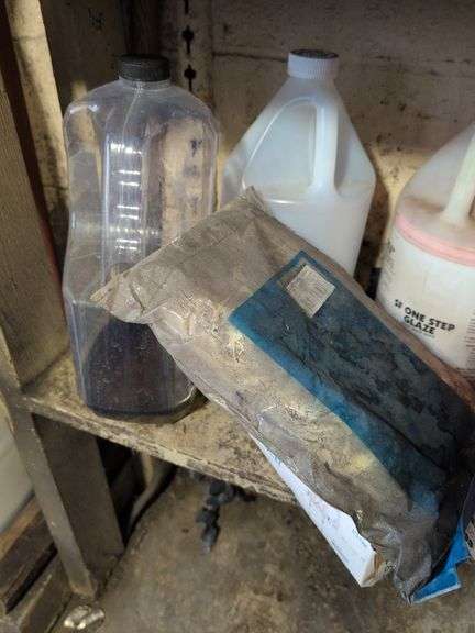 Shelf of shop rags and vehicle fluids