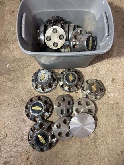 Tote of Chevy hub caps and parts