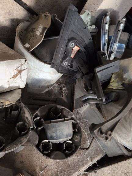 Contents of corner - car parts, center caps, and more