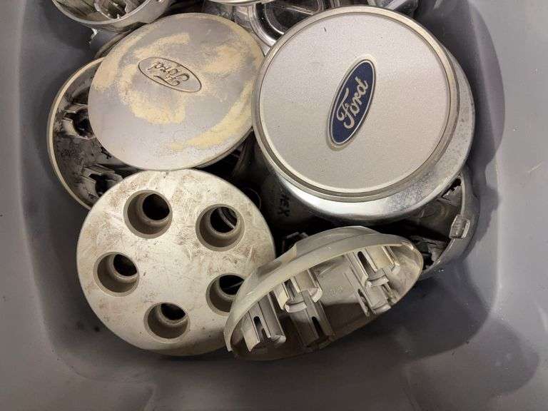 Tote of Ford hub caps and parts