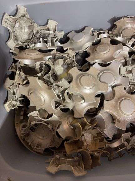 Tote of Chevy and Ford hub caps and parts