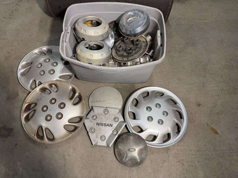 Tote of hub caps and parts -Nissan, Chevy, Ford and more