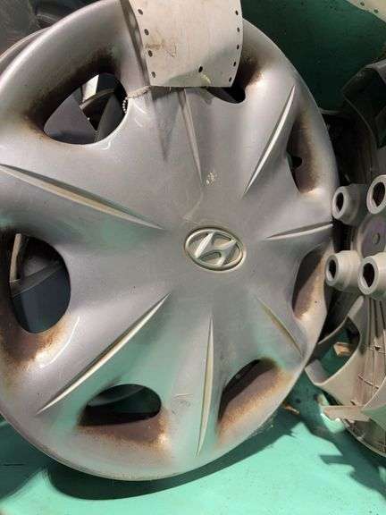 Large tote of hub caps and parts -Hyundai, Eagle and more