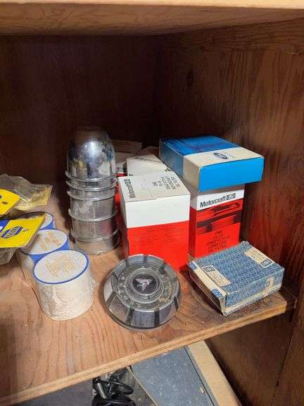 Contents of cabinet - oil filters, wiper blades, CB radios, manuals, and more
