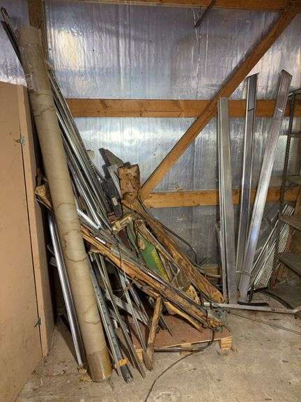 Corner of car parts and scrap metal pieces - as is