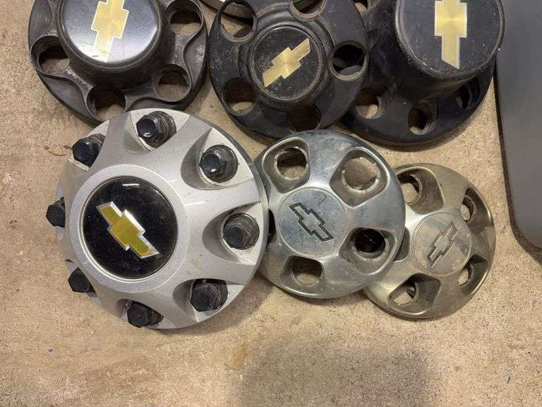 Tote of Chevy hub caps and parts