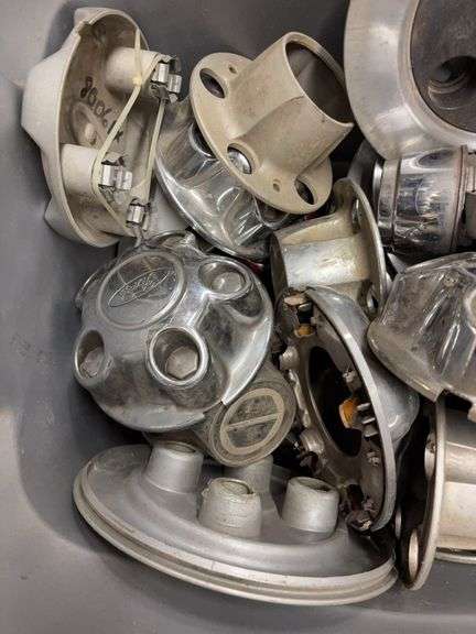Tote of Ford hub caps and parts