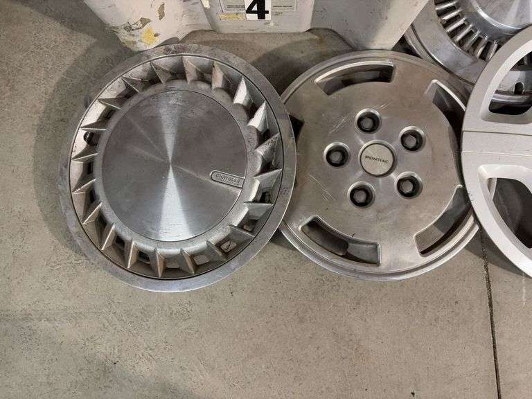 Large tote of hub caps and parts -Pontiac, Chrysler and more