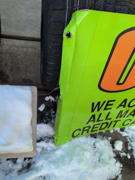 Large double-sided green metal sign - "Over 1000 tires in stock" - 8' x 28"