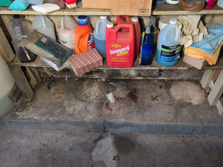 Shelf of shop rags and vehicle fluids
