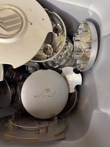 Tote of Miscellaneous hub caps and parts -see photos