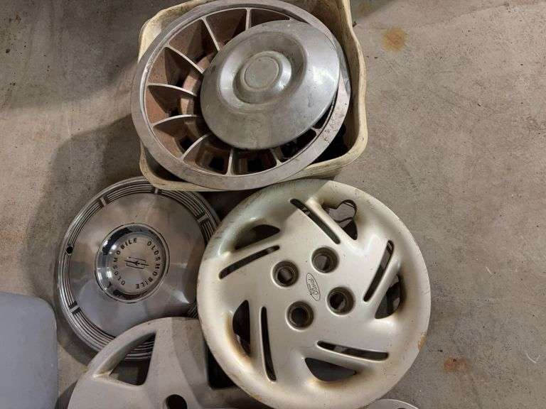 Tote of hub caps and parts -Ford, Oldsmobile and more