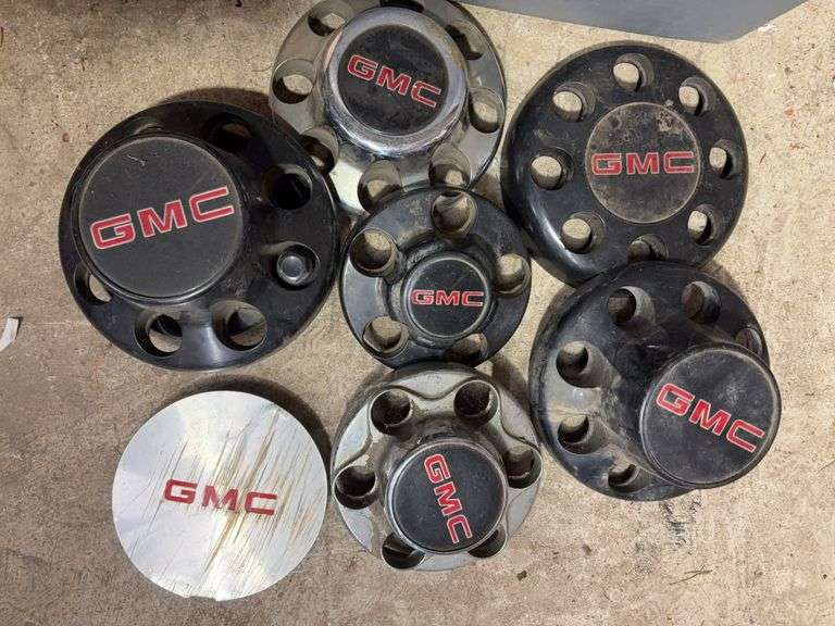 Tote of GMC hub caps and parts