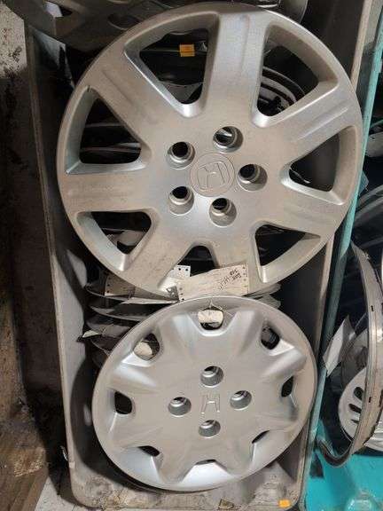 Tote of hubcaps - Honda, Cadillac, and more