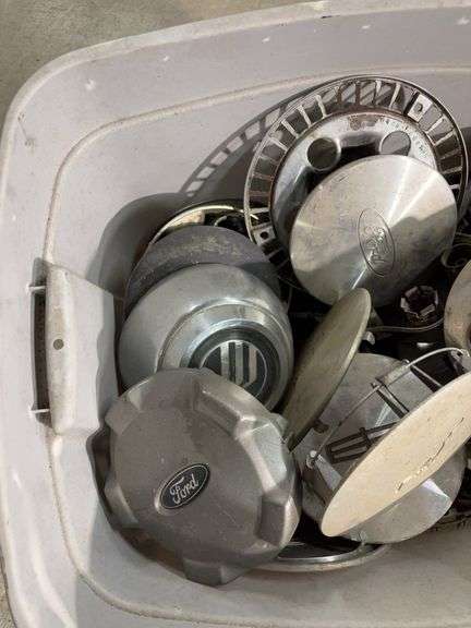Tote of miscellaneous hub caps and parts -Ford, Toyota and more