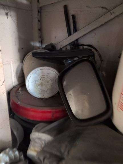 Contents of corner - car parts, center caps, and more